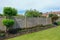 Neat flower bed with garden fence and lawn.