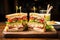 a neat halved clubhouse sandwich on a wooden board