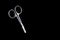 Neat little scissors for manicure and pedicure on a black background, isolate