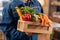 Neat nice courier holding a box full of healthy foods