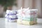 a neat stack of baby diapers with a gift ribbon