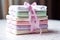a neat stack of baby diapers with a gift ribbon