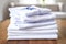 neat stack of folded white office shirts on a table