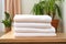 neat stack of three folded towels on bathroom shelf