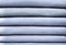 Neat stack of typical light blue denim, close up