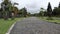 neat stone path. beautiful little street. streets in the middle of parks and gardens. cracked cement roads.