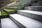 Neat and tidy grey stair steps made of stone and granite tiles with a curb.