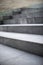 Neat and tidy grey stair steps made of stone and granite tiles with a curb.