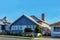 Neat and tidy houses beside highway in suburban Brisbane in Australia`s typical bright sunshine with metal and tile roofs