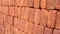 a neatly arranged pile of red bricks, pile of brickwork