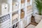 Neatly folded linen cupboard shelves storage at eco friendly straw basket placed closet organizer