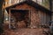 neatly organized firewood pile against rustic shed