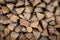 Neatly stacked wooden firewood. Stoke the fireplace. Background.