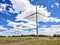 Nebraska windmills producing energy on a breezy cloudy day.