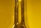 The Neck of a Glass Olive Oil Bottle with Yellow Background