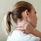 Neck shoulder pain, cervical vertebrae. Woman holds neck with pain cervical muscle spasm by hand. Disease of