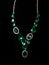 Necklace green stones decoration on a black background