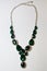 Necklace green stones decoration on a white background