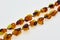 Necklace made of natural multi-colored amber. Solid translucent fossilized resin from extinct tertiary conifers. Decoration, beads