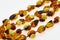 Necklace made of natural multi-colored amber. Solid translucent fossilized resin from extinct tertiary conifers. Decoration, beads