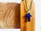 A necklace with a pendant of the holy cross hanging on a wooden stand.