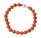 Necklace from polished red coral balls isolated