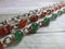 Necklaces Beads on chains Close-up Wooden light background Jewelry, Red Green Black Transparent