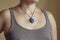 Neckline wearing elegant necklace with natural mineral gemstone