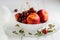 Nectarines, cherries with water droplets in white bowl