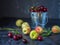 Nectarines and metal bucket filled with cherries, ripe fruits