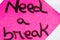 Need a break handwriting text close up isolated on pink paper with copy space. Writing text on memo post reminder