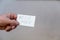 Need food. Words written in jagged letters. A man`s hand holds a white paper rectangle with text against a gray background