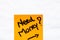 Need money handwriting text close up isolated on orange paper with copy space