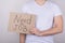 Need open vacancy concept. Cropped close up photo of guy in casual clothes holding placard with text  over grey background