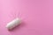 needle pierced or stick on white thread, symbol of garment industry, textile or fabric isolated pink background