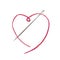 Needle with pink string in the shape of a heart
