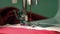 Needle plate sewing machine slides along the webbing tissue penetrating needle with red thread