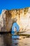 The Needle seen through the arch of the Manneporte cliff in Etretat, Normandy