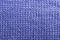 Needlework, hobbies, knitting. Background textile fabric with a knitted texture wool blue