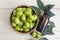 Neem green leaf and neem fruit on wooden table. Neem oil is moisturizing oil and contains various compounds that have insecticidal