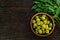 Neem leaf and neem fruit on wooden table.