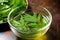 neem leaves in a glass bowl filled with water