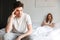 Negative offended loving couple lies in bed quarrel.