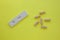 Negative pregnancy test and pills on a yellow background. Motherhood, children, pregnancy, concept of birth control