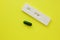 Negative pregnancy test and pills on a yellow background. Motherhood, children, pregnancy, concept of birth control