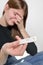 Negative Pregnancy Test. Sad Young Woman