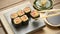 Negitoro roll, Tuna sushi roll served with pickled ginger and soy sauce on wooden background