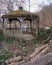 Neglected gazebo stands stolidly over canal