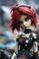 Neglected and lonely lifelike doll with bright red dyed hair in abandoned city backstreets - generative AI