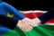 Negotiation handshake with flag of South Sudan
